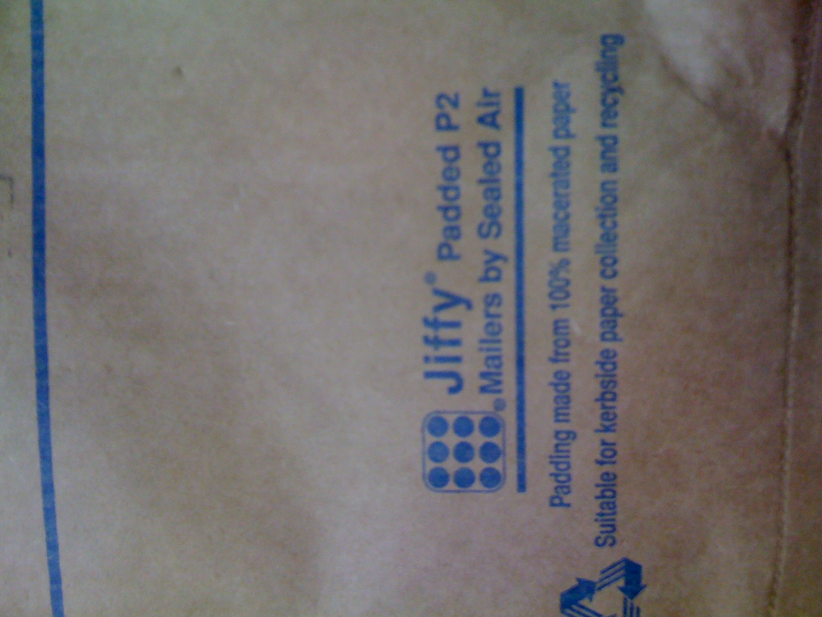 The back of a packing envelope that indicates it has padding that contains 100% macerated paper, whatever that is