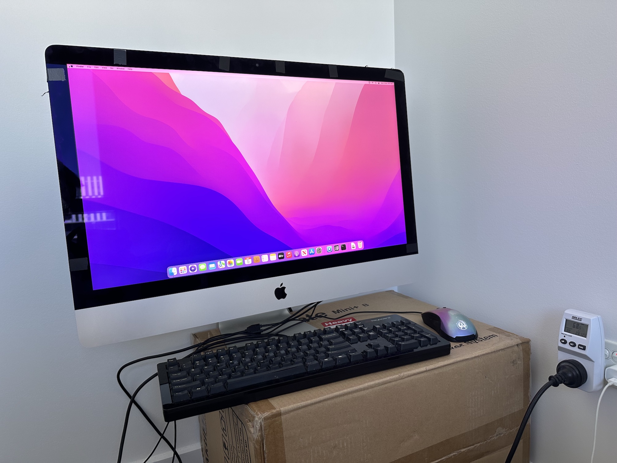 An iMac with its screen attached with electrical tape