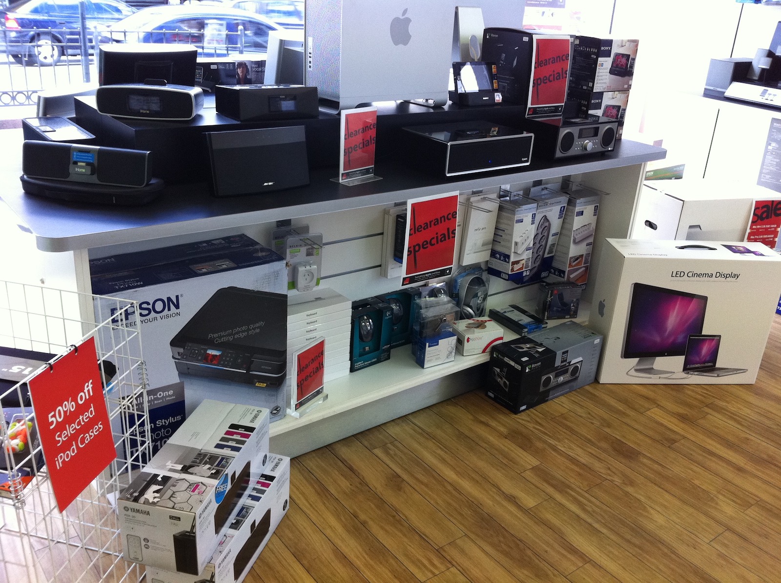 A retail display area showing iPod dock clearance specials and other accessories