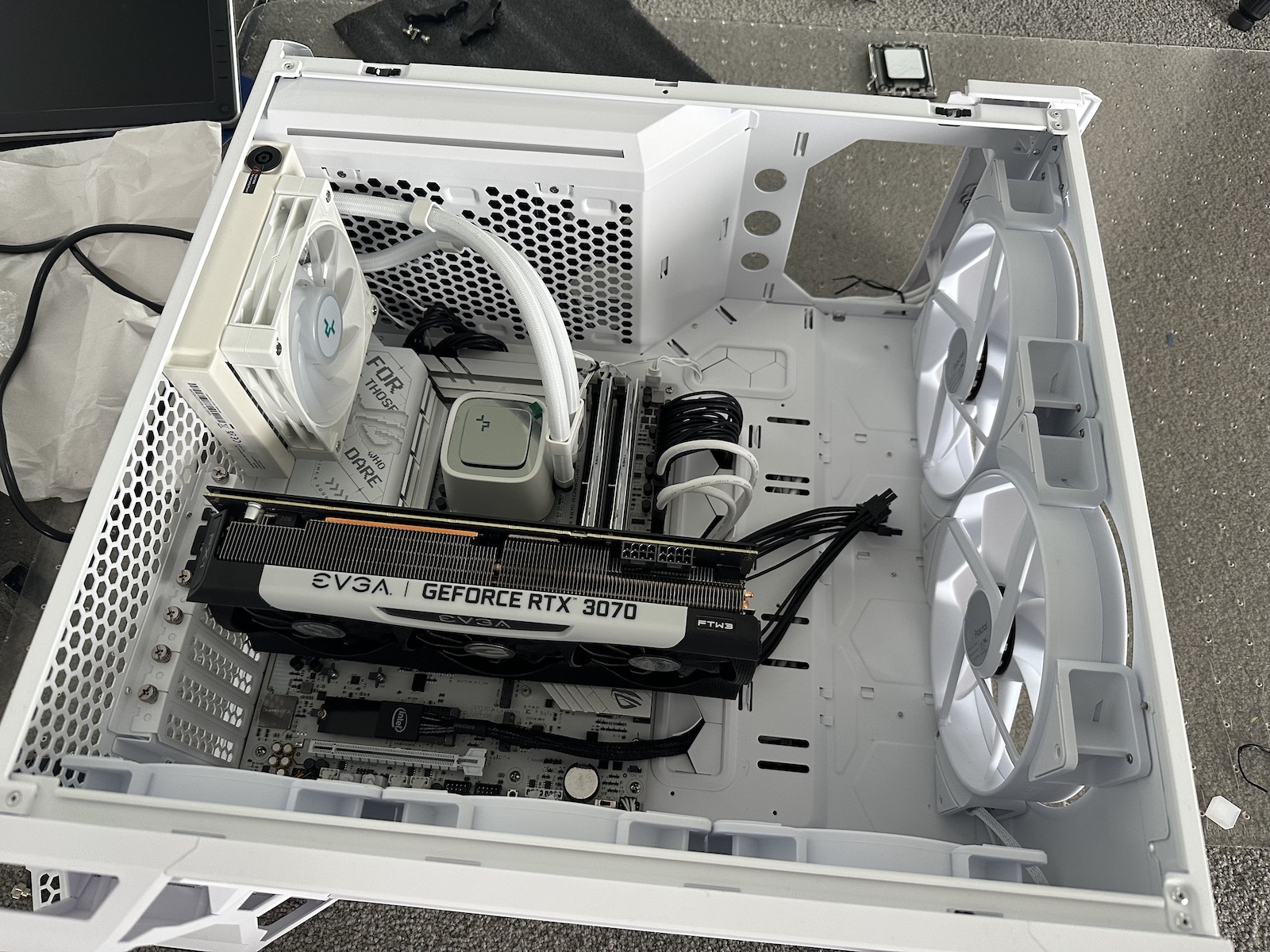 A mostly-white, half-built computer laying on its side